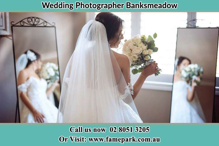 Photo of the Bride holding flower at the front of the mirrors Banksmeadow NSW 2019