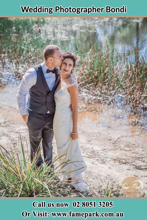 Photo of the Groom kissing his Bride near the lake Bondi NSW 2026