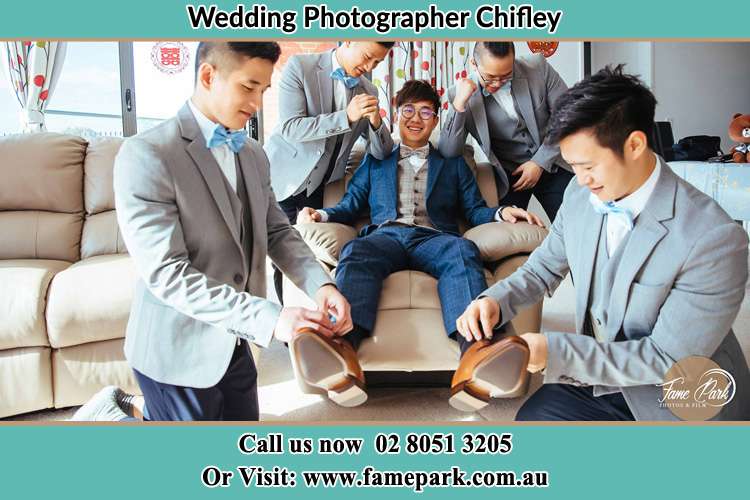 Photo of the Groom helping by the groomsmen getting ready for the wedding Chifley NSW 2036