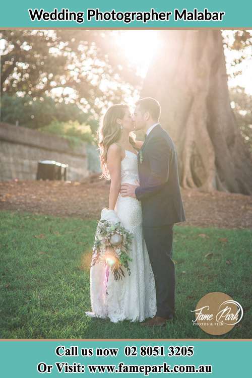 Photo of the Bride and the Groom kissing at the yard Malabar NSW 2036